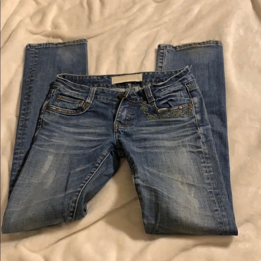 Jean with green stitching.